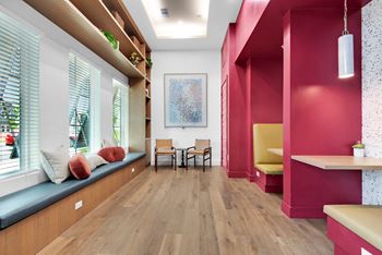 a living room with pink walls and a wood floor at The Enclave at Deer Moss Creek, Niceville
